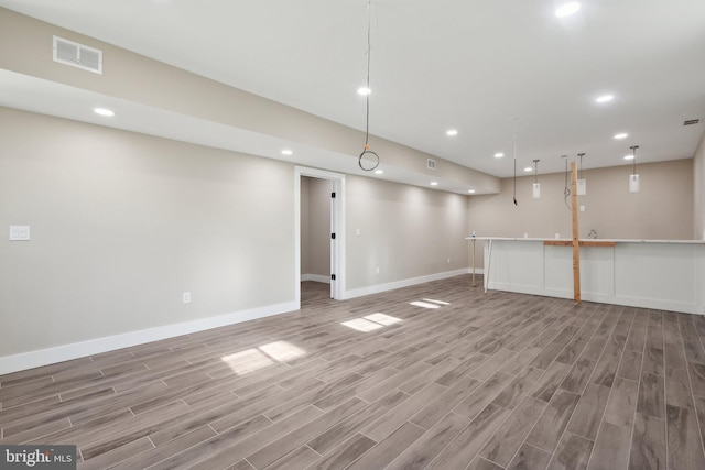 basement with light hardwood / wood-style flooring