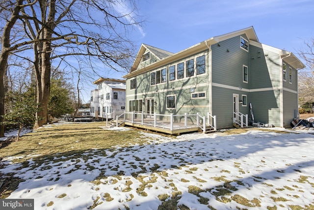 snow covered property featuring a wooden deck