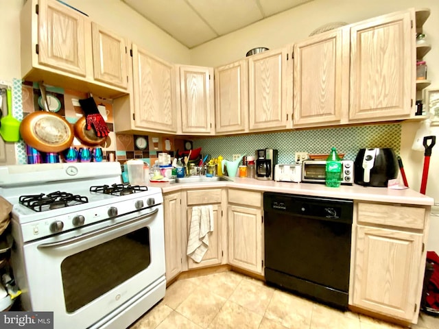 kitchen with light tile floors, white range with gas stovetop, sink, dishwasher, and light brown cabinetry