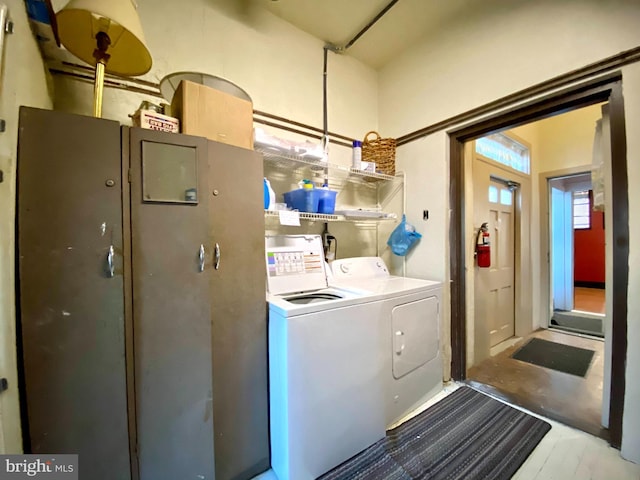 clothes washing area with separate washer and dryer