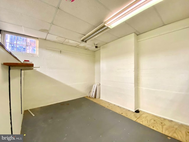 basement with a paneled ceiling