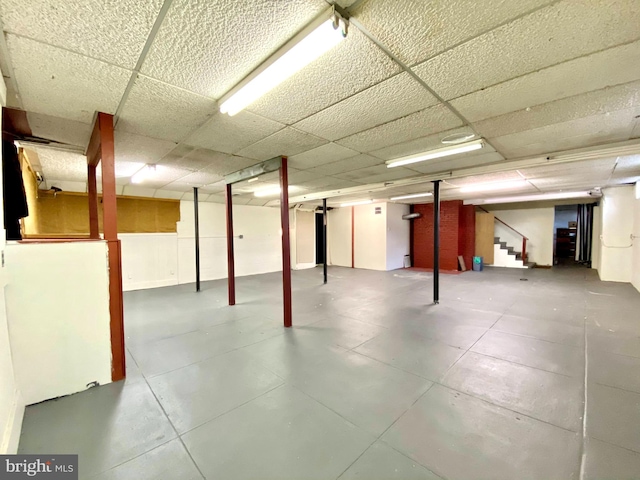 basement with a paneled ceiling