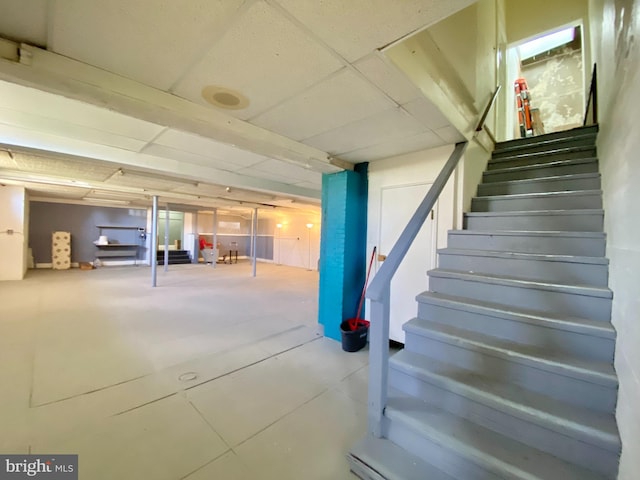 basement featuring a paneled ceiling