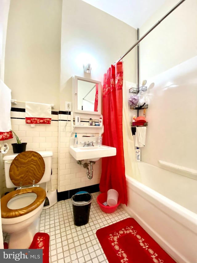 full bathroom featuring tile flooring, tile walls, shower / tub combo, sink, and toilet