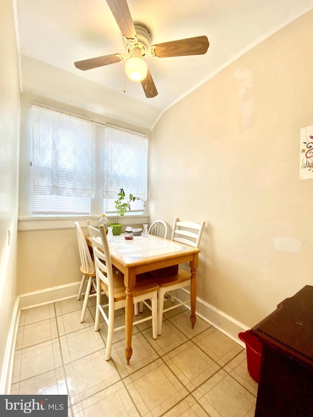 dining area with light tile flooring and ceiling fan