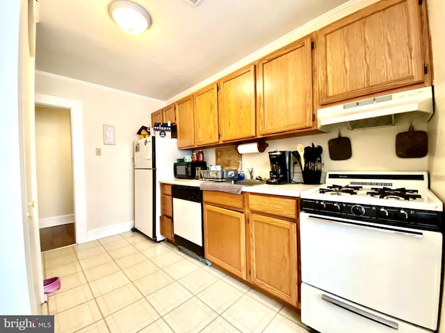 kitchen with ornamental molding, white appliances, and light tile floors