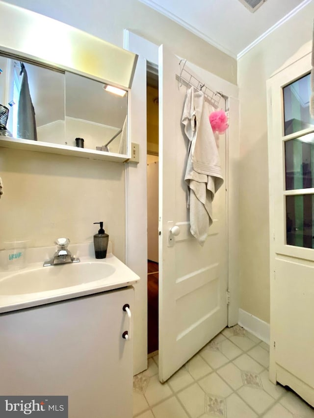 bathroom featuring vanity, tile floors, and ornamental molding