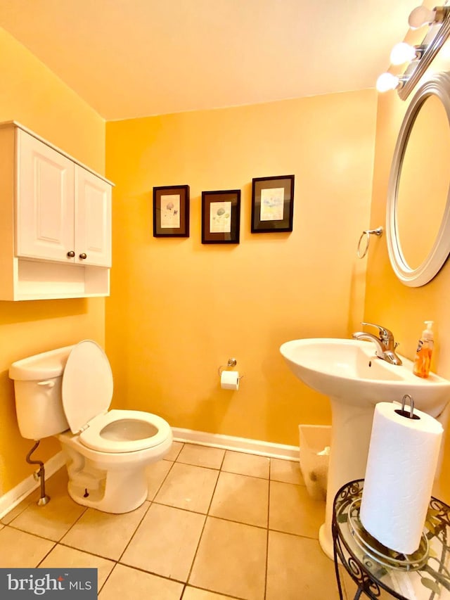 bathroom featuring toilet and tile floors