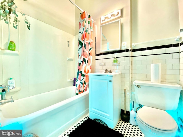 full bathroom with tile walls, toilet, tile floors, shower / bath combination with curtain, and vanity