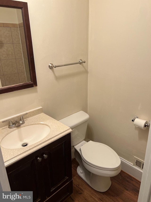 bathroom featuring vanity, toilet, and wood-type flooring