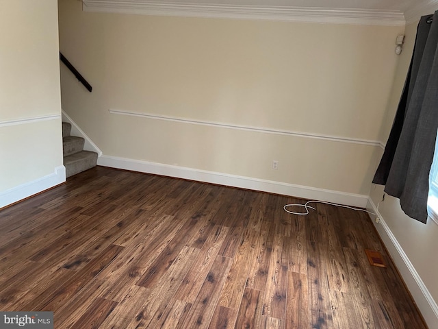 empty room with dark hardwood / wood-style floors and ornamental molding