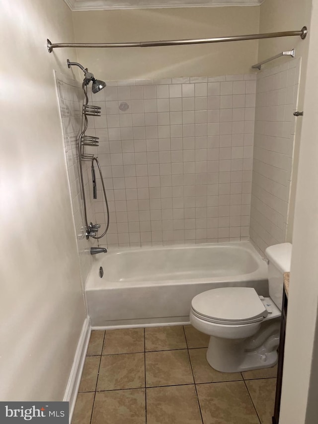 bathroom featuring toilet, tile patterned floors, and tiled shower / bath