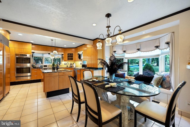 dining space with sink, light tile patterned flooring, a textured ceiling, and ornamental molding