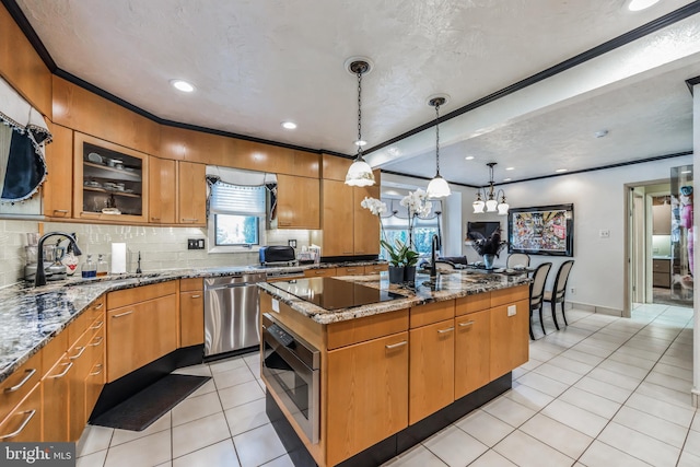 kitchen featuring sink, hanging light fixtures, stainless steel dishwasher, a kitchen island, and light stone counters