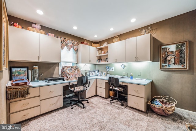 office space with light colored carpet and built in desk