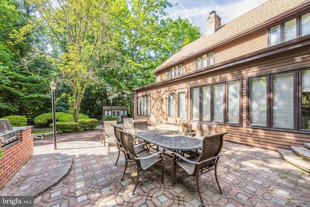 view of patio with a storage shed