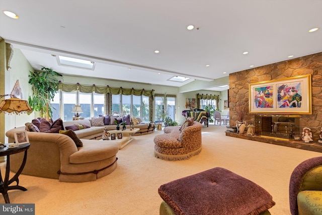 living room with a skylight, light carpet, and a water view