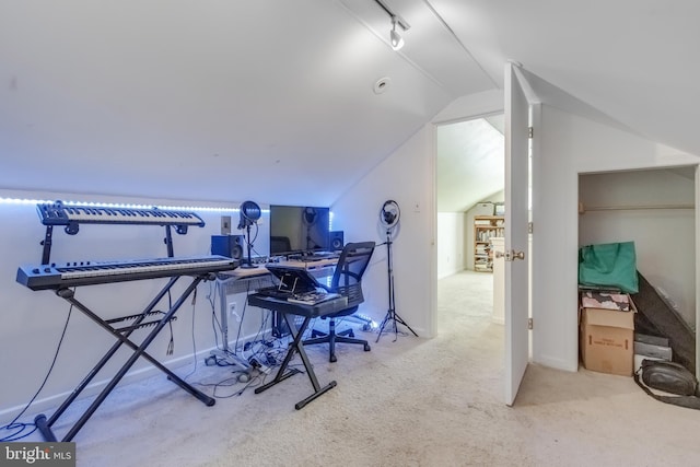 carpeted office featuring vaulted ceiling