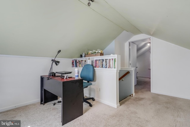 carpeted office space with vaulted ceiling