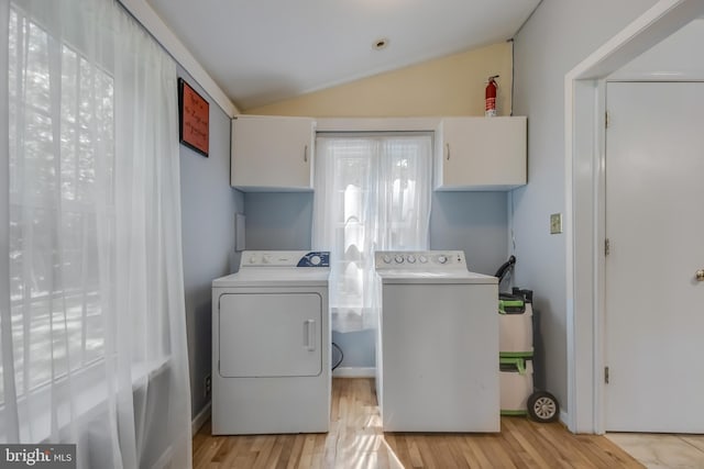 laundry area featuring light hardwood / wood-style flooring, cabinets, and independent washer and dryer