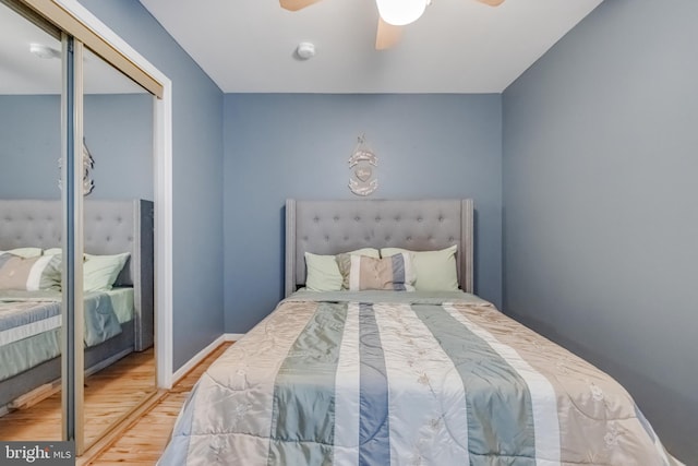 bedroom featuring ceiling fan, a closet, and wood-type flooring