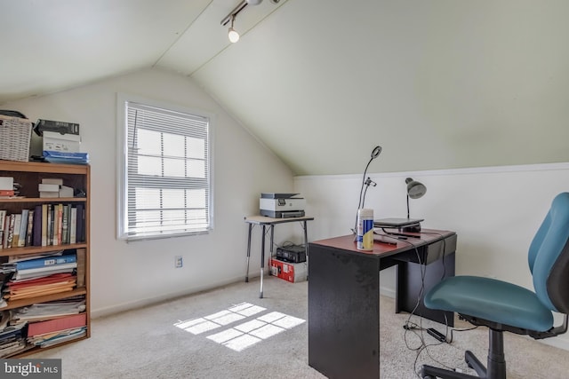 carpeted home office featuring lofted ceiling