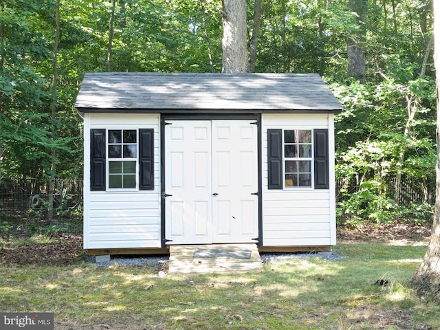 view of outdoor structure featuring a lawn