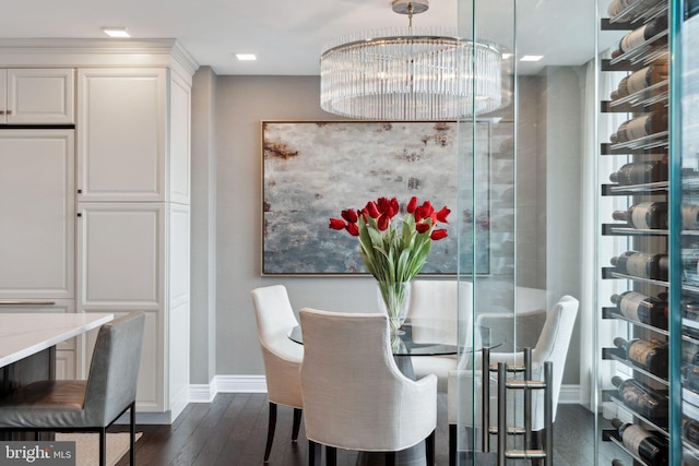 dining space with dark wood-type flooring and a notable chandelier