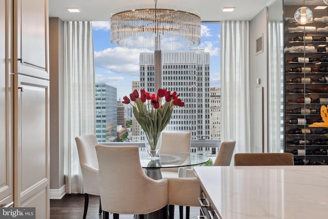 dining area featuring expansive windows, dark hardwood / wood-style flooring, a wealth of natural light, and an inviting chandelier