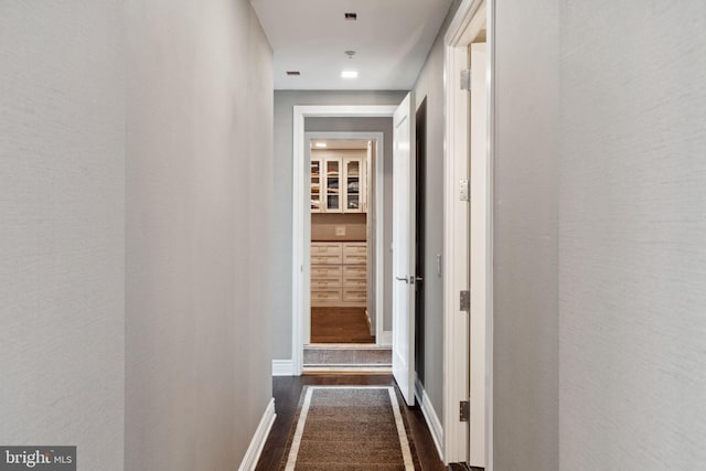 hallway featuring dark wood-type flooring