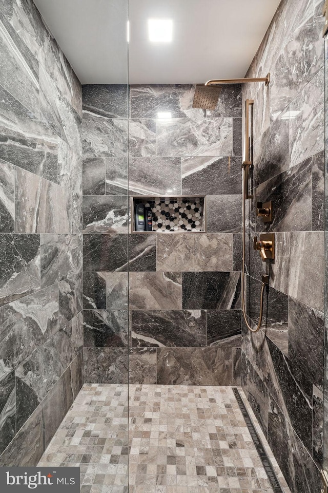 bathroom with a tile shower