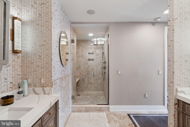 bathroom featuring tile patterned flooring, vanity, and a shower with shower door