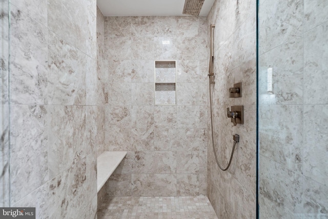 bathroom featuring a tile shower