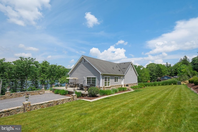 back of house with a yard and a patio