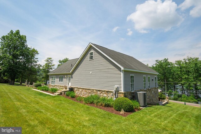 view of property exterior featuring a yard and central AC