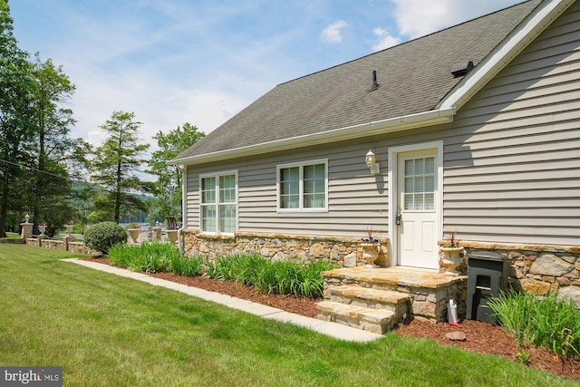 property entrance with a yard