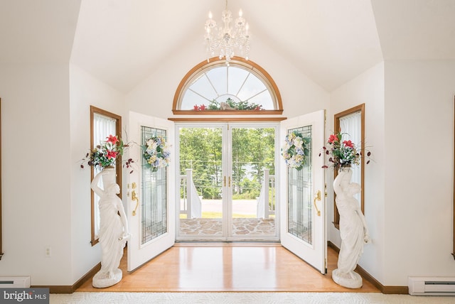 entryway with french doors, a baseboard radiator, light wood-type flooring, and a notable chandelier