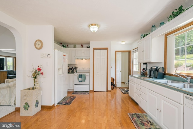 kitchen featuring white appliances, light hardwood / wood-style flooring, and white cabinetry