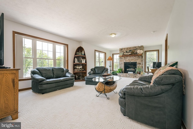 living room featuring a textured ceiling, a fireplace, and light carpet