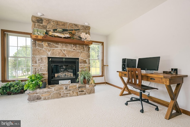 office space with a fireplace, carpet, and vaulted ceiling