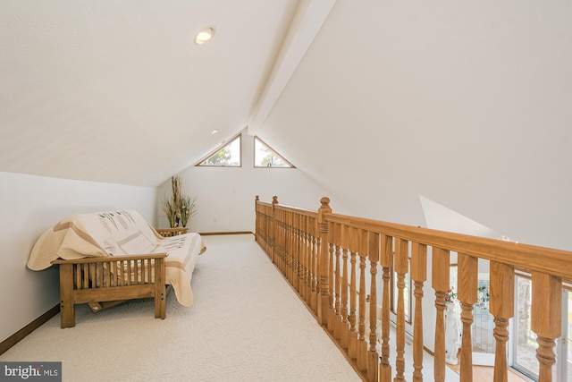 sitting room with vaulted ceiling with beams and carpet floors