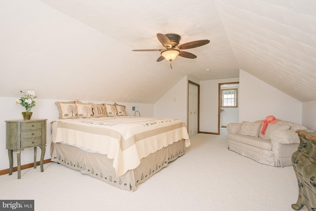 carpeted bedroom with a closet, ceiling fan, and lofted ceiling