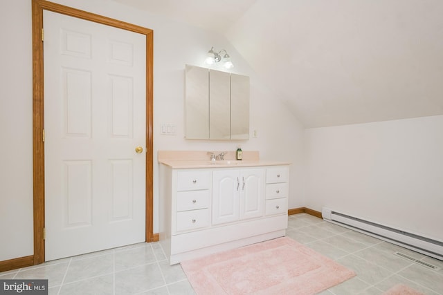 bathroom featuring tile patterned flooring, vanity, a baseboard radiator, and vaulted ceiling