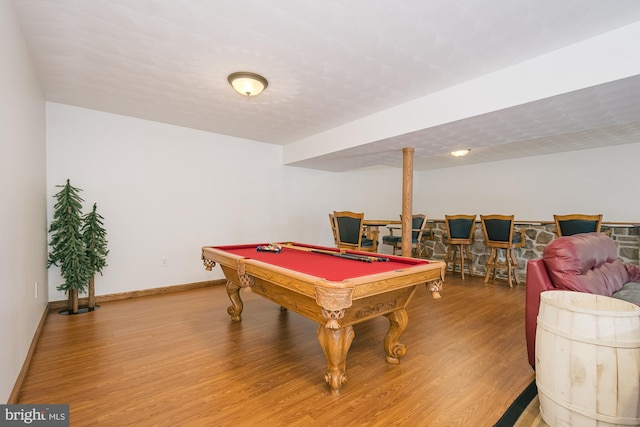 recreation room with bar, wood-type flooring, and billiards