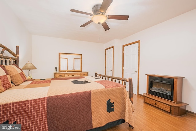 bedroom with light wood-type flooring and ceiling fan