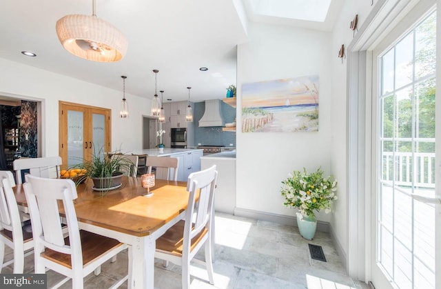 dining area with visible vents, baseboards, recessed lighting, french doors, and a skylight