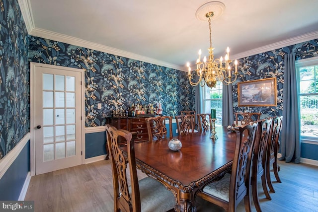 dining room featuring wallpapered walls, plenty of natural light, and ornamental molding