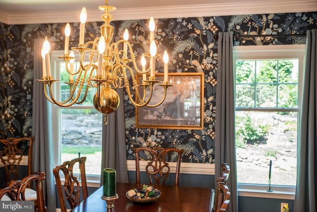 dining area featuring a chandelier, wallpapered walls, and crown molding