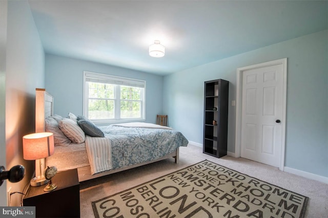 carpeted bedroom featuring baseboards