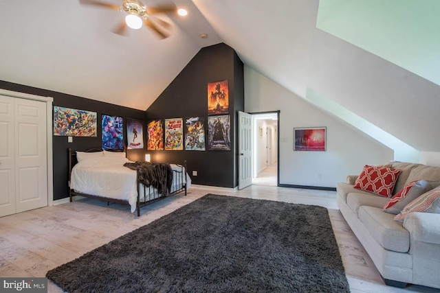 bedroom featuring lofted ceiling, wood finished floors, and baseboards